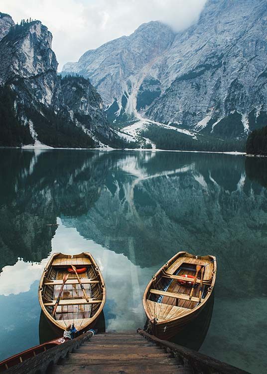  – Photograph of a pair of boats in a lake with foggy mountains in the background