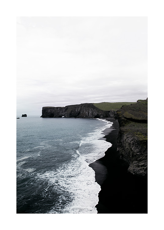  - Photograph of coast with black cliffs, black beach and ocean waves