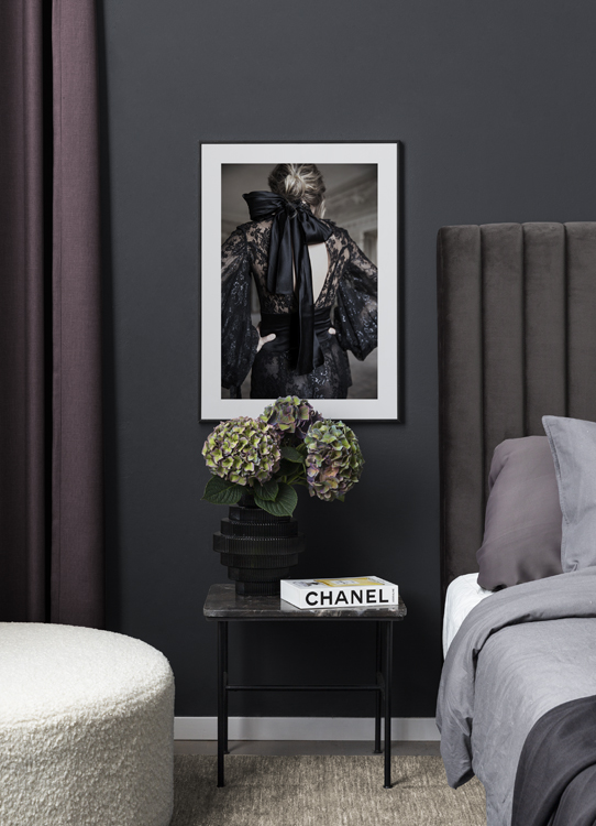  – Photograph of a woman wearing a black dress in lace with a satin bow in black at the neck